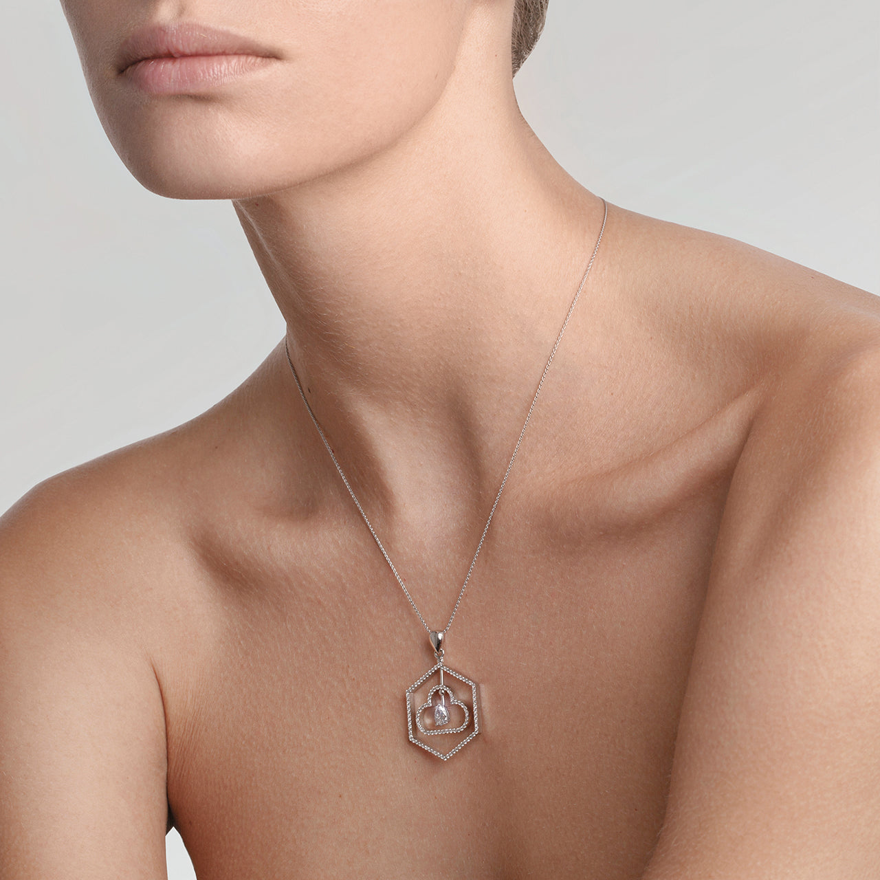 Conceptual golden pendant representing 3 states of water on the model
